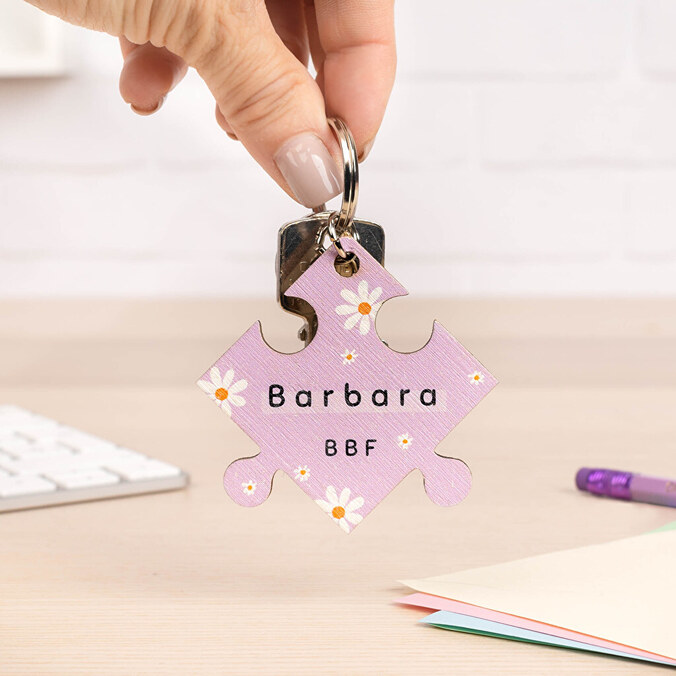 Personalised wooden keyring with the shape of a puzzle piece