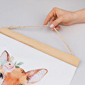 Personalised wooden poster hanger
