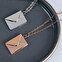 Necklace with envelope pendant and engraved letter
